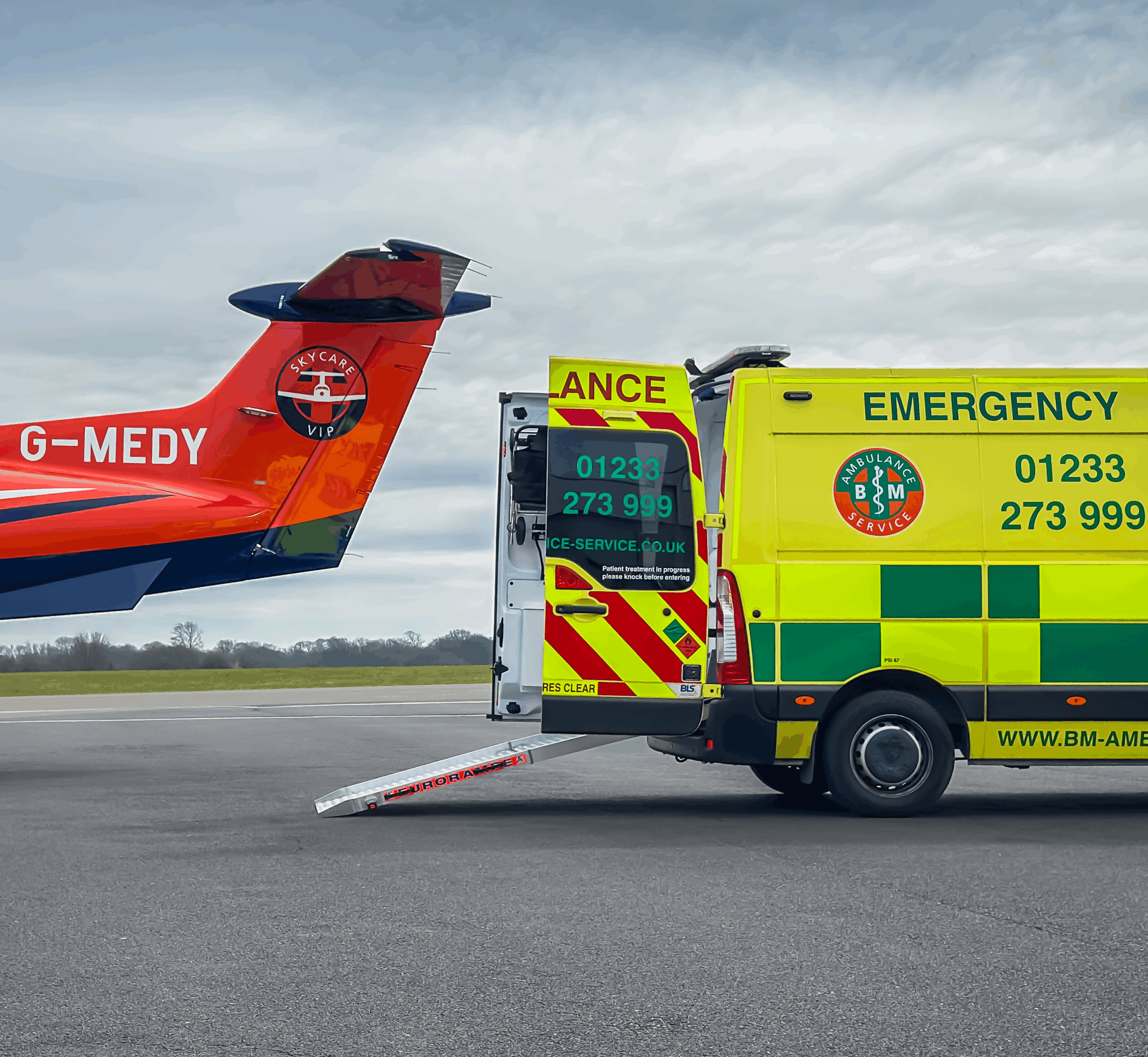 Ambulance collecting patient airside at UK